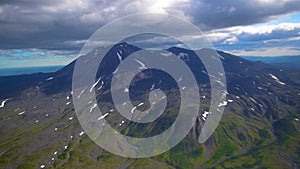 The view from the helicopter on the mountains and volcanoes of Kamchatka Krai, Russia