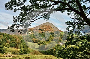 View of Helm Crag, framed within leafy branches