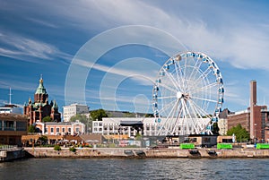 View of Helsinki harbor with Uspensky orthodox cathedral and a skywheel during a summer afternoon