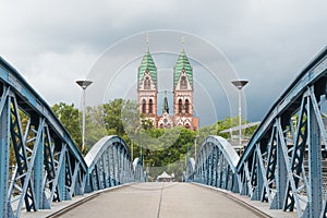 View of the Herz Jesu Church and the Wiwili BrÃ¼cke bridge in Freiburg im Breisgau, Germany