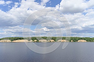 View of the high bank of the river with sandy precipices forested, Volga, Russia