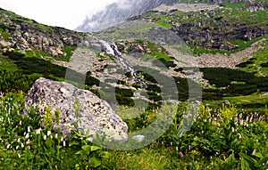 View of the high mountains with a waterfall.