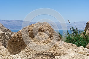 View from a high view of the Dead Sea and blue sky on the horizon through the high mountains of Ein-Gedi national park Israel.