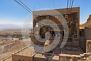 View from a high view of the landscape around the Dead Sea, the parking place in the desert and the starting station of the cable
