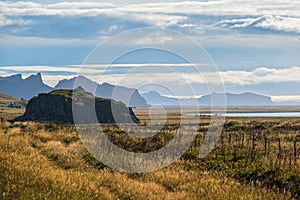 View from highway road during auto trip in Iceland. Spectacular Icelandic landscape with  scenic nature: mountains, ocean coast,