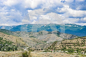 View from the highway to the mountain plateau Karabi-Yayla. Crimean landscape with mountains, vineyards and blue sky