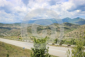 View from the highway to the mountain plateau Karabi-Yayla. Crimean landscape with mountains, vineyards and blue sky with cirrus