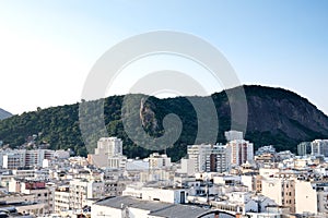 View of hill in Parque Estadual da Chacrinha, in copacabana, next to the many Copacabana rooftops. Taken from hotel rooftop