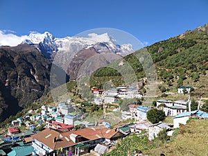 View of hill slopes of Namche Bazaar town and snow-capped peaks of Kongde Ri in the background, Solukhumbu District, Nepal