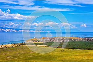 View from hill to Khuzhir village of Olkhon island and Maloe More bay of lake Baikal, Russia. Picturesque summer landscape,