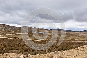 View of hills and small roadside lagoons and various vegetation, in Shupluy