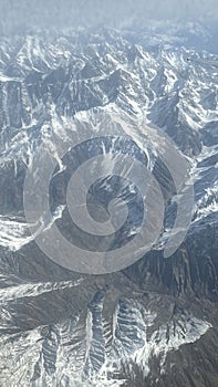 View of the Hindu Kush mountains in the Himalayas in India from an Airplane