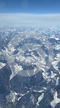 View of the Hindu Kush mountains in the Himalayas in India from an Airplane