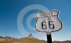 A view of a historic Route 66 sign with a sky blue background