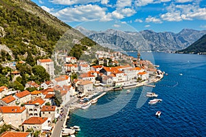 View of the historic town of Perast at famous Bay of Kotor on a beautiful sunny day with blue sky and clouds in summer, Montenegro