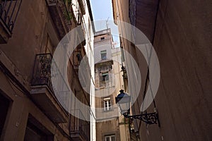 View of the historical narrow street with old residential buildings in center of Barcelona. Spain