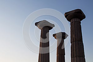 View of historical ruins with clear, blue sky background captured in the temple of Athena at the ancient city of Assos