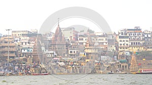 View of the holy city of Varanasi from the ghats. Boats anchored on teh banks of the river