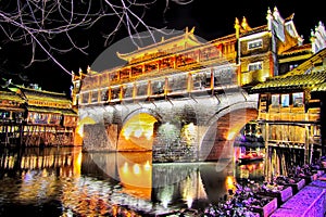 View of Hong bridge at night over the Tuojiang River Tuo Jiang River in Fenghuang old city Phoenix Ancient Town,Hunan Province