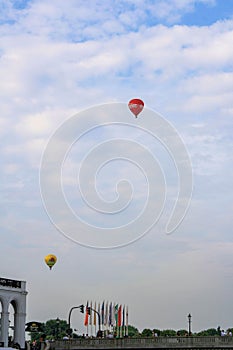 View of hot air balloon fly in high sky at Kleine Alster in summer with clouds in blue sky background