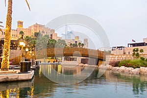 View of the hotel Burj al Arab out of the Park with a water channel of the Madinat in Dubai