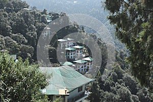 View of Hotel Omkar  and dense forest from Shedup Choephelling Buddhist Temple, Mussoorie, Uttarakhand photo