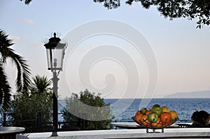 View from hotel room luxury and elegant mediterranean terrace with fruit bawl in morning sun.