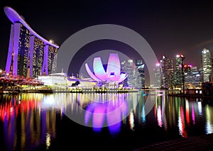 View of the hotel ÃÂ«Marina Bay SandsÃÂ», Art Science Museum and Marina Bay Financial Centre in the evening in Singapore.