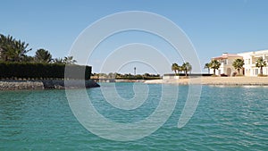 View of hotels and houses from a boat floating on channels of El Gouna