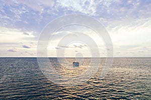 View of a house floating in the sea at sunset