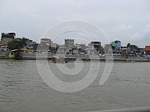 View of houses and ferry boat along the Pasig river, Manila, Philippines