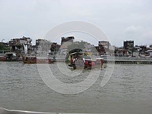 View of houses and ferry boat along the Pasig river, Manila, Philippines