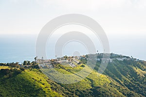 View of houses, green hills, and the Pacific Ocean from Top of the World, in Laguna Beach, California