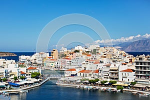 View of the houses, street and Lake Voulismeni in Agios Nikolaos, Crete island, Greece.
