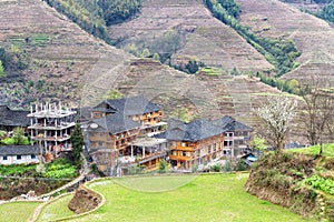 view of houses in village between terraced hills