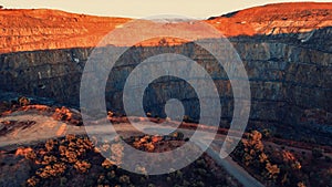 View of a huge open pit mine in rocky terrain