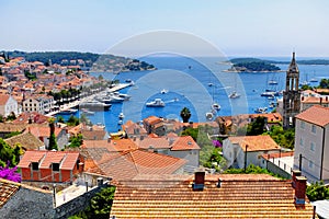 View of Hvar town harbor with lots of red roofs in Croatia