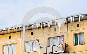 Icicles and snow on the roof of the house
