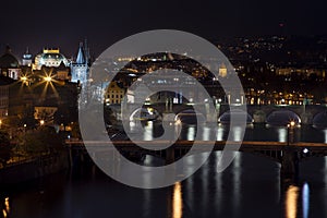 view of illuminated bridges on the Vltava river in the center of Prague at night at czech republic