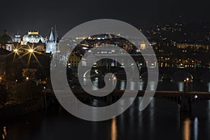 view of illuminated bridges on the Vltava river in the center of Prague at night at czech republic