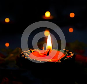 A view of illuminated lit Diya/lamp on black background