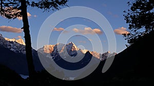 View of impressive mountain Thamserku with the top illuminated by the evening sun in the Himalayas near village Thame, Nepal.