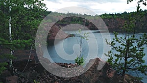 View on inactive abandoned granite quarry with beautiful blue water.