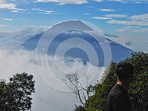 the view of Indonesia& x27;s Sumbing mountain shrouded in clouds