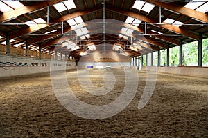 Panoramic view of an empty indoor horse riding arena photo