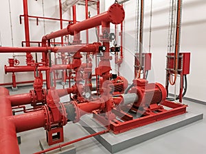 View at industrial electrically powered water pumps and pipes, this pumping group serves for water injection for building fires,