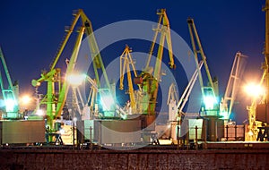 View of the industrial port at night - ships waiting for loading and unloading, cargo transportation by sea