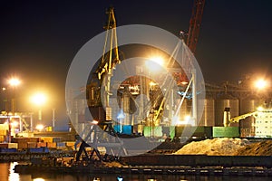 View of the industrial port at night - ships waiting for loading and unloading, cargo transportation by sea