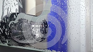 View from Inside car being washed in automatic car wash machine. Car wash service in action. Drying with hot flow of air. Final