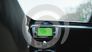 View inside car young man driving use navigation app on greenscreen mock-up display. Navigation online app. Business